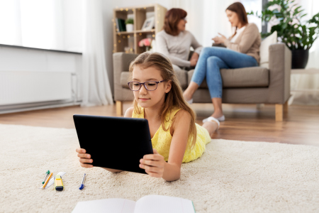 girl laying down studying on laptop